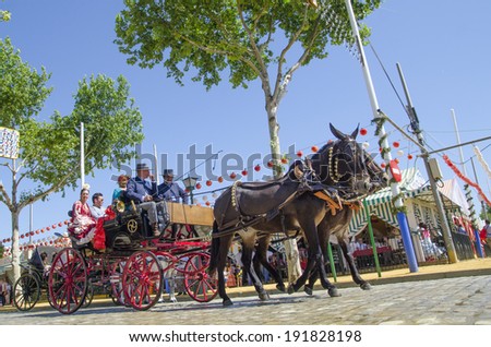 SEVILLE, SPAIN-MAY 8: People mounted on a carriage horse in fair Seville on May 8, 2014 in Seville