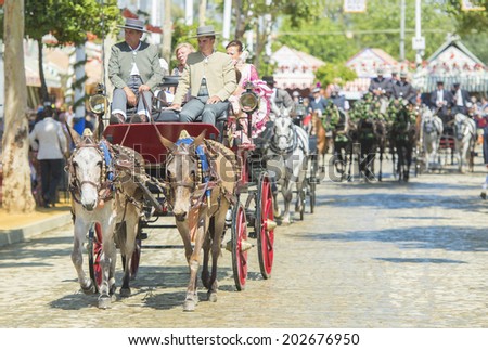 SEVILLE, SPAIN-MAY 8: People mounted on a carriage horse in fair Seville, on May 8, 2014 in Seville.