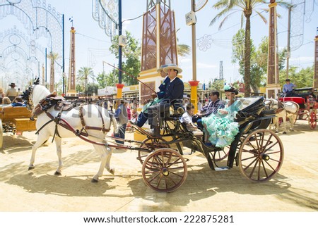 JEREZ DE LA FRONTERA, SPAIN-MAY 17: People mounted on a carriage horse, on fair ride on May 17, 2014 in Jerez de la frontera.
