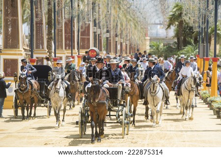 JEREZ DE LA FRONTERA, SPAIN-MAY 17: People mounted on a carriage horse and horse, on fair ride on May 17, 2014 in Jerez de la frontera