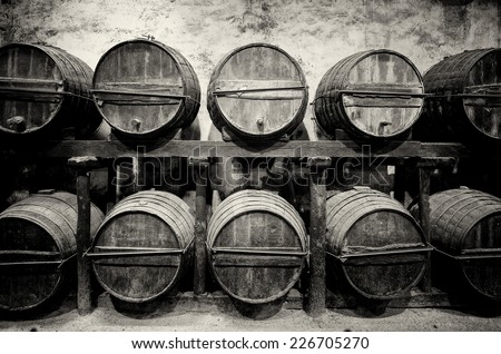 Barrels stacked in the winery in black and white