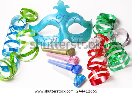 Carnival mask with colorful streamers and party horns on white background