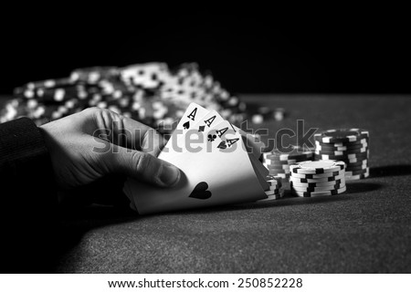 Hand of four aces in poker in black and white