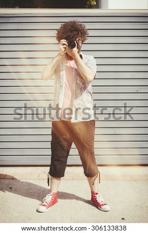 Man with photo camera with analog film effect