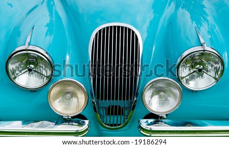 stock photo Front of blue classic car showing grill headlights and fender 