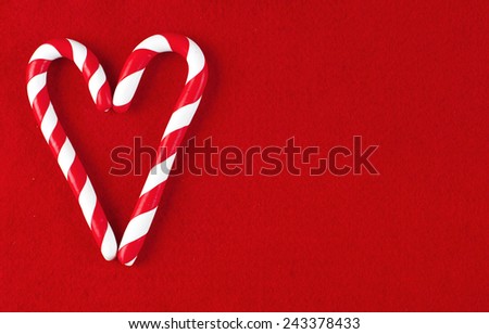 Valentine Heart made from Christmas candies isolated on red background