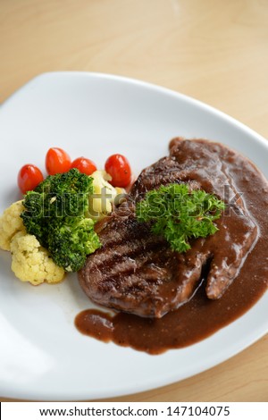 Beef steak with a red wine sauce and vegetable