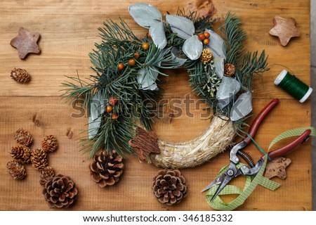 Top down view of florist\'s worktable. Making of Christmas wreath. Copy space - perfect for a festive card.
