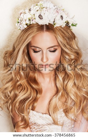 Portrait of affectionate blond woman. Beautiful bride with wedding makeup, hairdo and wedding decorations. Wedding ideas and bridal style.
