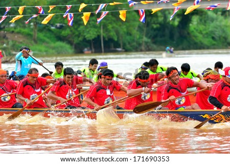 CHUMPHON, THAILAND-OCT 20: Unidentified rowers in Climbing Bows toward Snatching a Flag native Thai long boats compete during Native Long Boat Race Championship on Oct 20, 2013 in Chumphon, Thailand.
