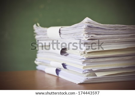 stack of paper on blackboard