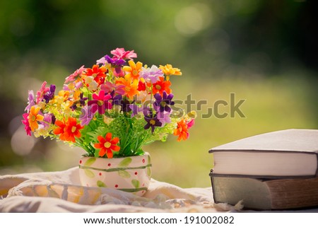 bouquet of flowers and book in nature background