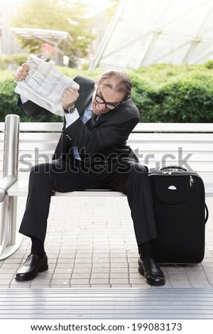 Portrait of Angry businessman with newspaper in his hands