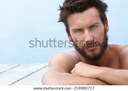 Close up Portrait of Confident Gorgeous Handsome Man with No Shirt Posing at the Sea