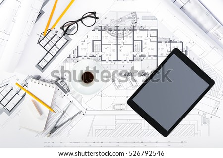 Top View of Construction plans with Tablet and drawing Tools on blueprints; Architectural and Engineering Housing Concept.
