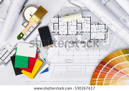 Top View of Construction plans with whitewashing Tools,Colors Palette and Smart phone on blueprints; Architectural and Engineering Housing Concept.