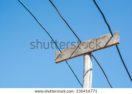 the vintage lectricity wire and wooden pole on blue sky