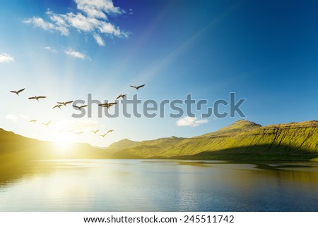 Seascape, mountains on the horizon. The Faroe Islands. The sunrise.