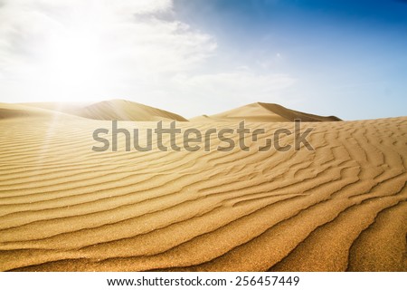 Blue sky and sand dunes with footprints. Canary islands, Maspalomas. Sunset