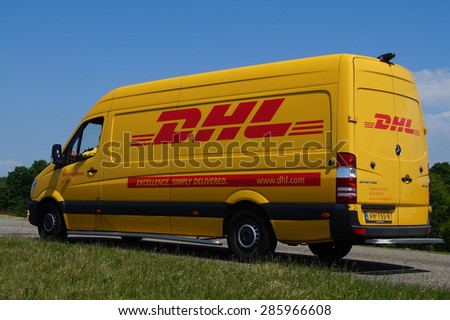 Almere Poort, Flevoland, The Netherlands - June 10, 2015: DHL delivery van parked by the side of the road. DHL Express is a division of Deutsche Post providing international express mail services.