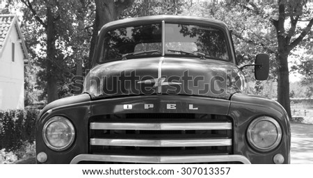 Houthalen, Belgium - August 5, 2015: 1950s Opel Blitz 1.75T truck parking on the side of the road (in vintage 1950 black white retro style, front view)