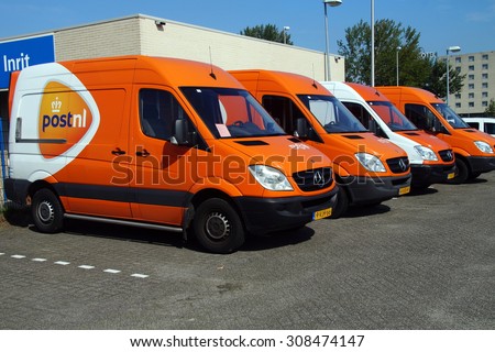 Almere, Flevoland, The Netherlands - August 21, 2015: A row of PostNL delivery trucks parked on the street of Almere. PostNL (Post.nl) is a large mail, parcel company operating in Europe