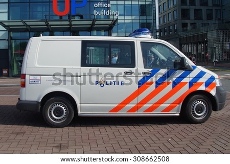 Amsterdam, The Netherlands - August 22, 2015: Dutch National Police Van , Volkswagen Transporter, parked on a city street in front of a office building. Nobody in vehicle