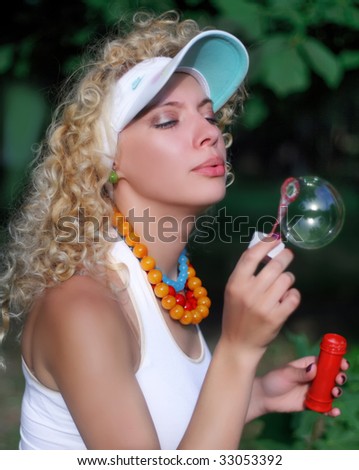 The curly-headed girl with soap bubbles