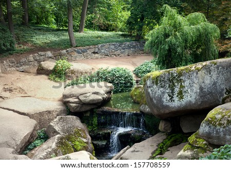 Stony landscape. Waterfall in the park.