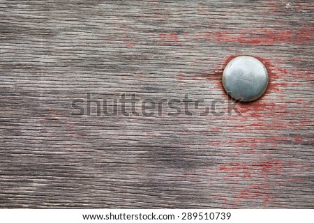 Aged wooden background with nail head. Close-up, texture.