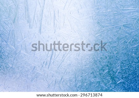 Ice crystals formed on the inside surface of windows. Blue and white color. frosting window closeup.