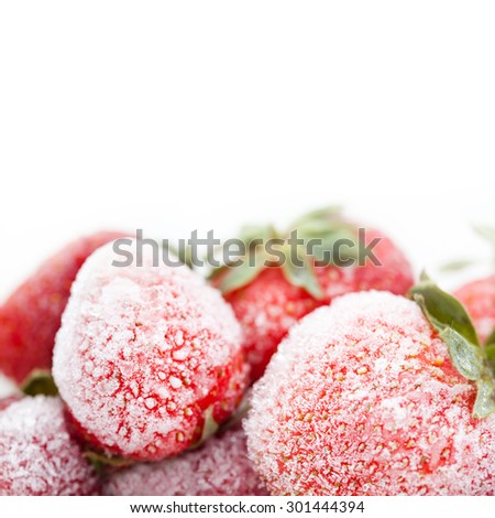 Frozen red strawberries. red fruit berries with a seed-studded surface, icy texture. Macro view, detailed ice crystal. copy space. white background. Shallow depth of field.