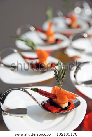 Sun-lit seafood snacks on banquet table