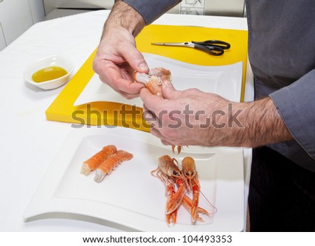 Chef is making seafood appetizer on professional kitchen