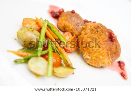 Creative nuggets with stir fried vegetables on plate close-up