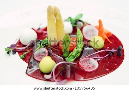 Beetroot carpaccio with fresh vegs on plate, close-up