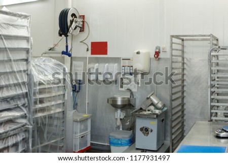 Food processing plant storage room with rack trolleys and hand washing area