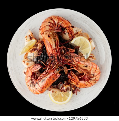 Jumbo prawns and grilled squids with black rice isolated on white background