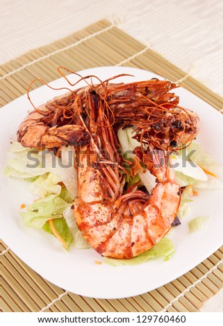 Seared Jumbo prawns with lettuce on restaurant table