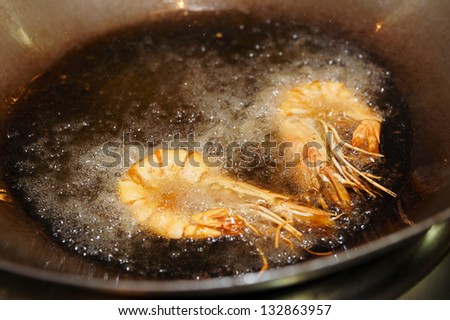 Prawns being fried in wok pan, asian restaurant