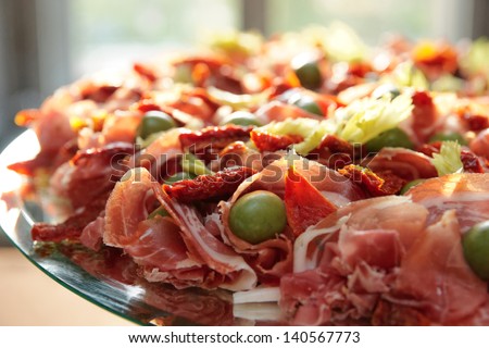 Platter with spanish cured ham on table