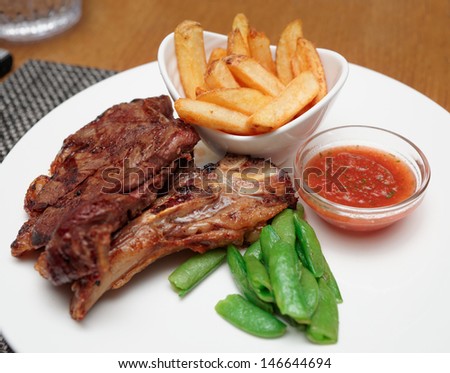 T-bone steak with french fries and hot sauce