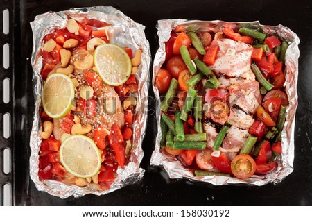 Roasting pan with two uncooked dishes shot from above