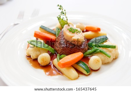 Tenderloin steak with steam cooked vegetables and  bone marrow