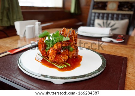 Wok fried shrimps with sweet sauce and coriander leaves, chinese food