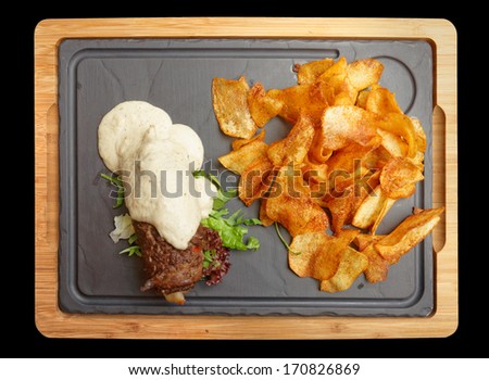 Meat rolls with white sauce isolated on black background