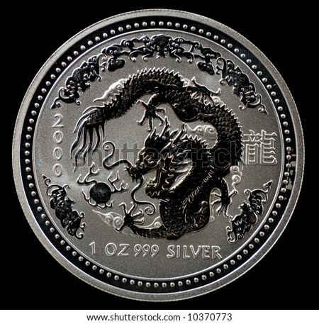 Australian silver coin with dragon, isolated on black background