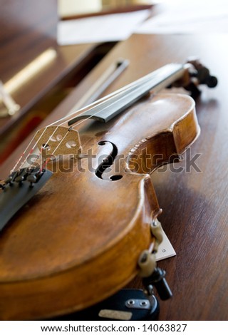 Violin lying on piano, back light