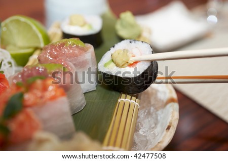 Fancy sushi set on restaurant table, eating with sticks, extremely narrow focus