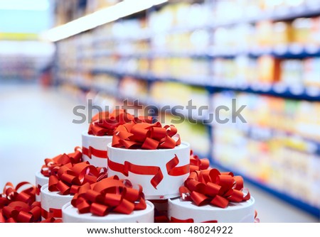 Candy boxes in supermarket, shelf with food in background